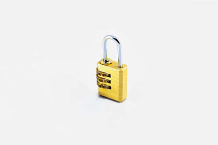 Golden Travel sentry padlock Key on the White Backgroundの写真素材
