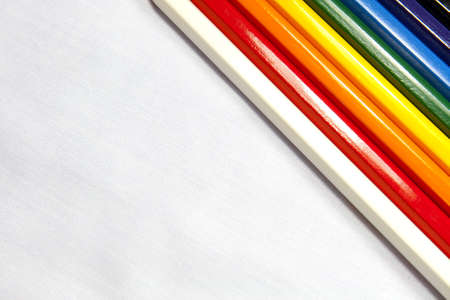 Colored pens cross the white canvas in backgroundの写真素材