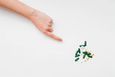 Pills in hands on a white background.
