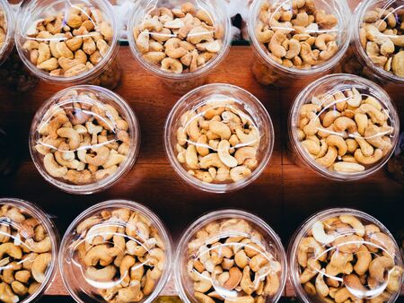 Nuts in plastic cups photographed from above.の写真素材