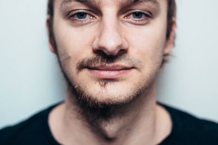 A close portrait of a shaved man on one side only.の写真素材