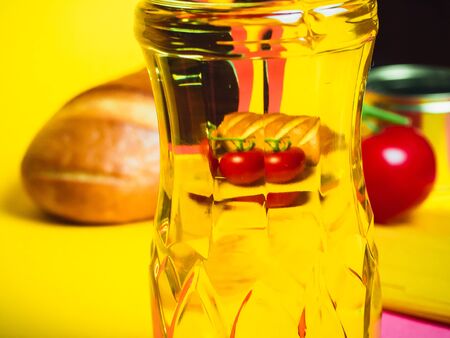 Paper bag with Food supplies crisis food stock for quarantine isolation period on yellow. Pasta, canned food, bananas, butter, bread. Food Delivery, Donation, Coronavirus Quarantine. Copyspace.の写真素材