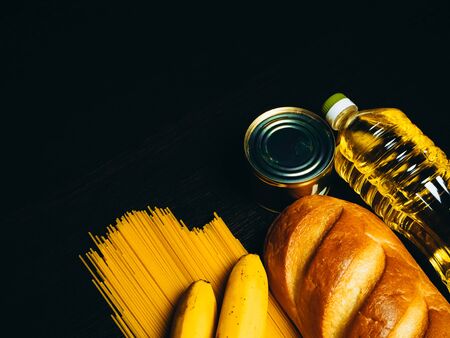 Food supplies in crisis. Vermicelli, pasta, canned food, bananas, butter, bread. Food Delivery, Donation, Coronavirus Quarantine. Copyspace.の写真素材