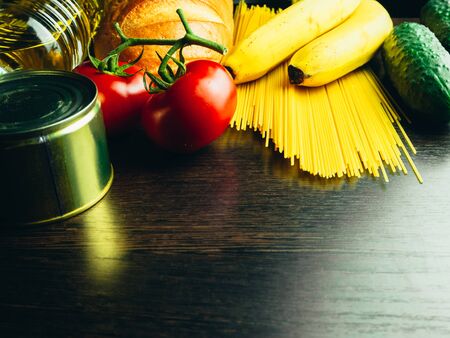 Food supplies in crisis. Vermicelli, pasta, canned food, bananas, butter, bread. Food Delivery, Donation, Coronavirus Quarantine. Copyspace.の写真素材