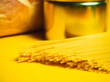 Food supplies crisis food stock for quarantine isolation period on yellow. Vermicelli, pasta, canned...