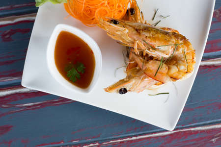 Top view of Grilled king prawns with fresh chilli and garlic relish with sauceの写真素材