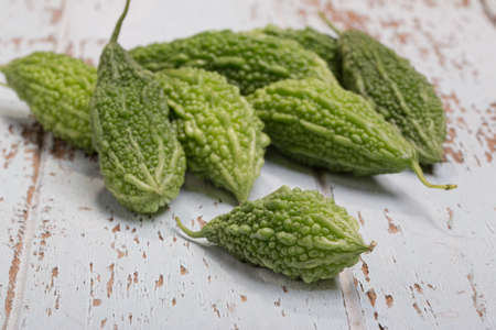 Bitter Cucumber on coloured-wood table