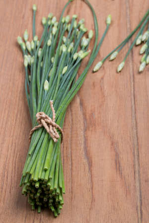 Garlic Chives on wood table backgroundの写真素材