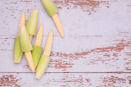 Top View of Baby Corn on wood table backgroundの写真素材