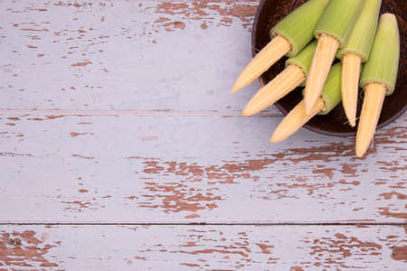 Top View of Baby Corn in the wood bowl on wood table background