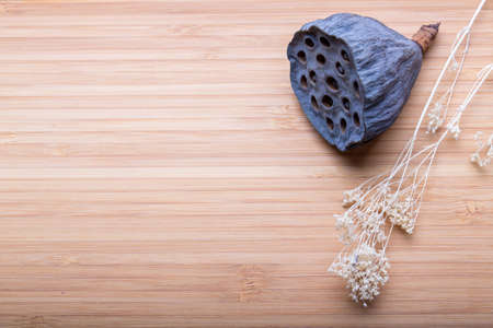 Dried lotus flowers on wood table, close-up shotの写真素材
