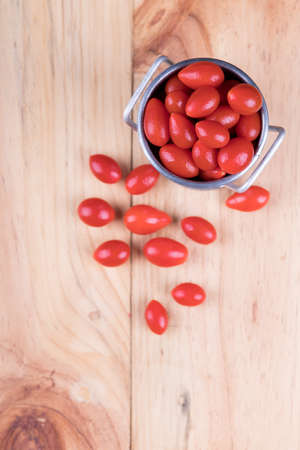 Grape tomatoes or Cherry tomatoes on wooden table, selective focusの写真素材