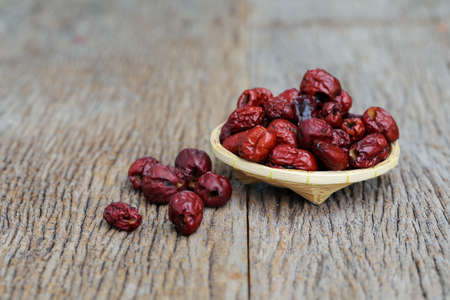 Dried red date or Chinese jujube on wooden table, selective focusの写真素材