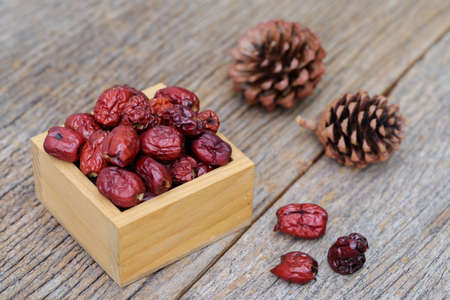 Dried red date or Chinese jujube on wooden table, selective focusの写真素材