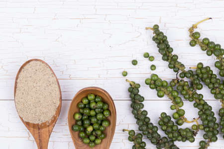 Fresh Black Pepper on white wooden backgroundの写真素材