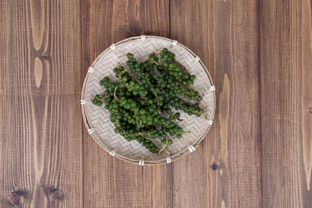 Fresh Black Pepper on wooden backgroundの写真素材