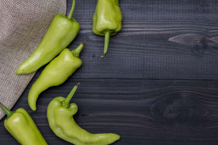 Green Peppers on dark wooden background, top view with copy spaceの写真素材
