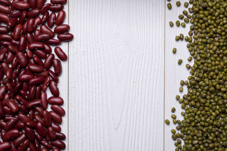 Red Kidney Bean and Mung Bean on white wooden textured table, food background with copy spaceの写真素材