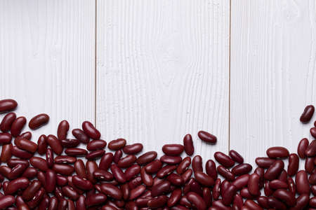 Red Kidney Bean on white wooden textured table, food background with copy spaceの写真素材