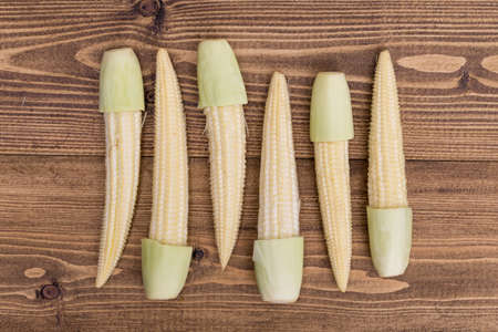 Top view of Fresh baby corn on wooden backgroundの写真素材