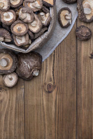 Top view of Dried shiitake mushroom on wooden table with copy space, selective focus