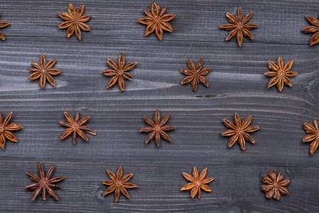 Top view of Star Anise on wooden table in pattern, food backgroundの写真素材