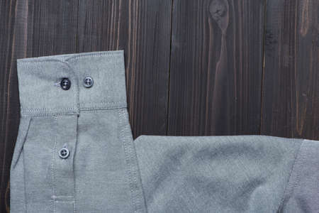Close up bright sleeve shirt on wooden background with copy space