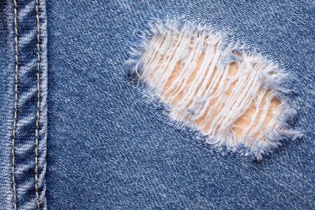 Close up shot of torn denim jeans textureの写真素材