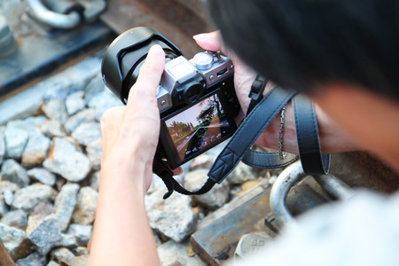 Closeup  photographer taking picture with digital camera