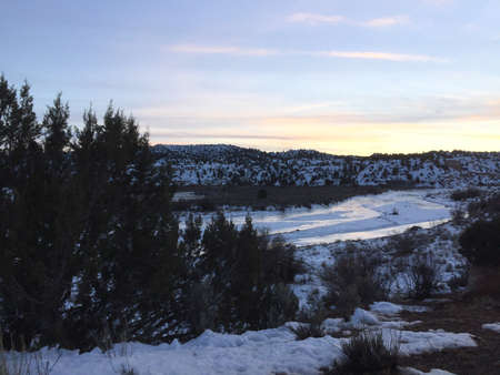 sunset over a river in winterの写真素材