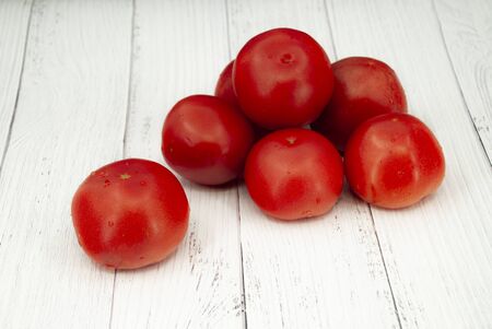 Tomatoes on wooden tableの写真素材