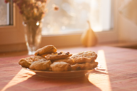Baked hand made biscuits on the plate on the table in the sun shining Waldorf kindergartenの写真素材