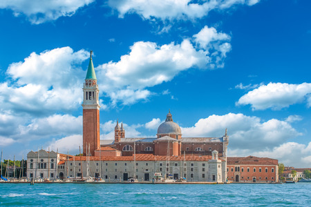 Venice landmark, view from sea of Piazza San Marco or st Mark square, Campanile and Ducale or Doge Palace with colorful blue sky and white clouds. Italy, Europe.の写真素材