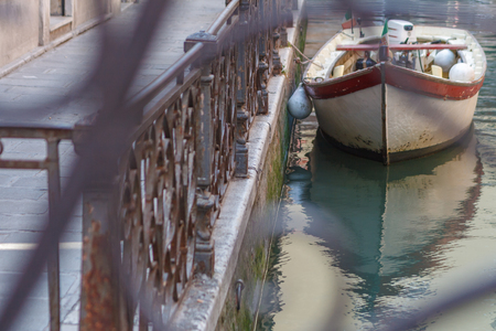 Simple Venice - Boat parked at the canal fence. Conceptual image from the brige. Italyの写真素材