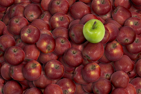 pile of red apples with green apple on topの写真素材