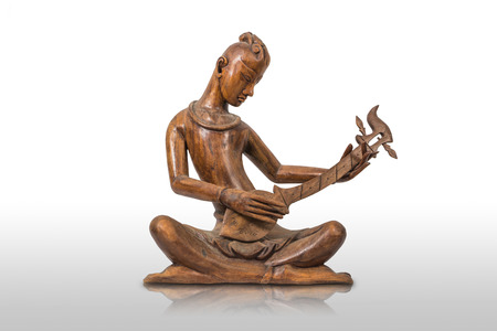 Wooden Thai musician figurine on white backgroundの写真素材