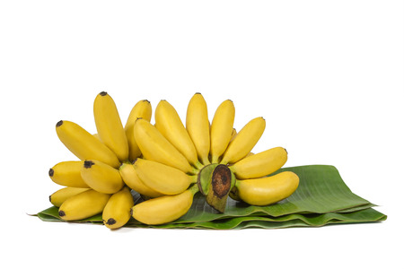 Banana on a green leaf isolated on white backgroundの写真素材