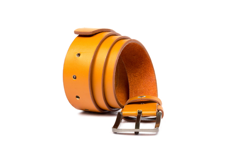 Orange leather belt on white backgroundの写真素材