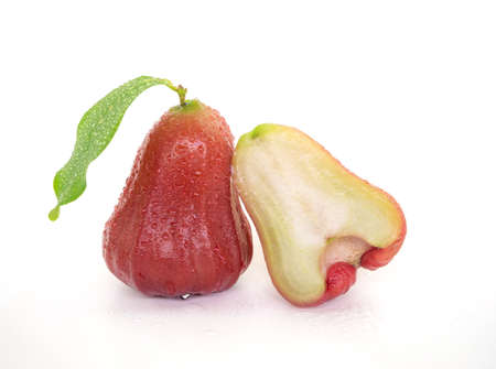 isolated rose apple with green leaves and water droplets on white backgroundの写真素材