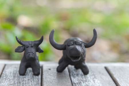 buffalo clay sculpture on wooden backgroundの写真素材