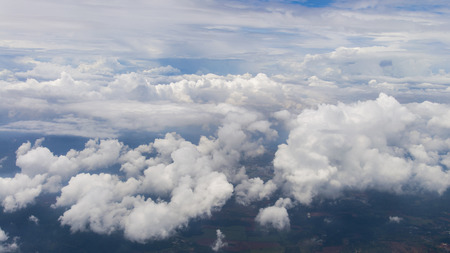 many clouds sky with cloud background look like white island in ocean from bird eyeview from airplantの写真素材