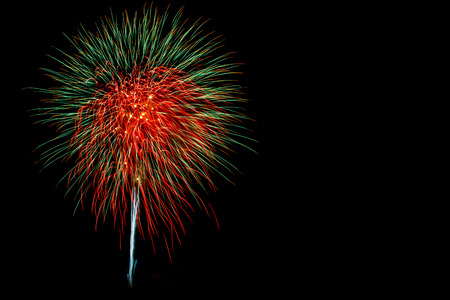 x'mas and happy new year red and green firework celebrate on isolated backgroundの写真素材