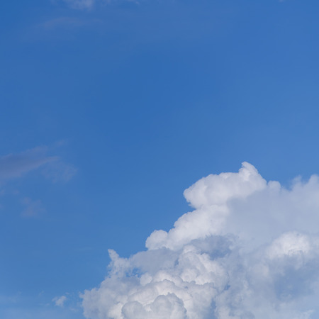 cloudscape. top view from the window of an airplane flying in the clouds. clear blue sky under high...