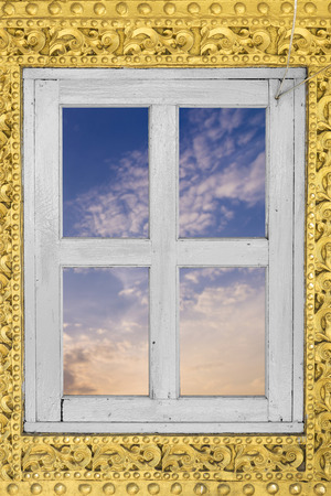 golden myanmar wood craft on wall and windowの写真素材