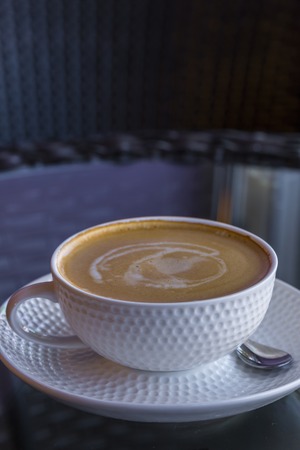hot coffee in mug on black glass backgroundの写真素材