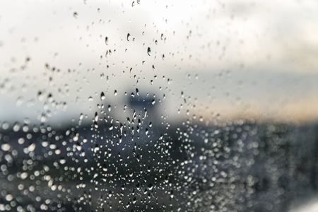 Rain / Water drop of rain on glass with outdoor backgroundの写真素材