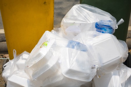 close up  View of bagged rubbish on street Overflow in Plastic Bin, Overflowing trash problem of...