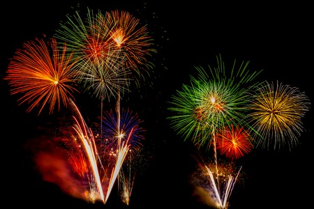 Beautiful colorful firework display for celebration happy new year and merry christmas on black isolated backgroundの写真素材