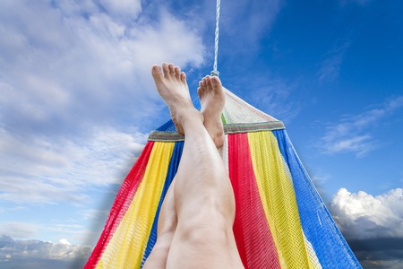 Lazy in relaxtion travel time. sleep relax on colorful Hammock beach and sunshire sky on a summer dayの写真素材