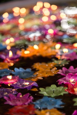 Floating flower candles in water  for make merit in the Buddhist, .Colourful candles lotus.の写真素材